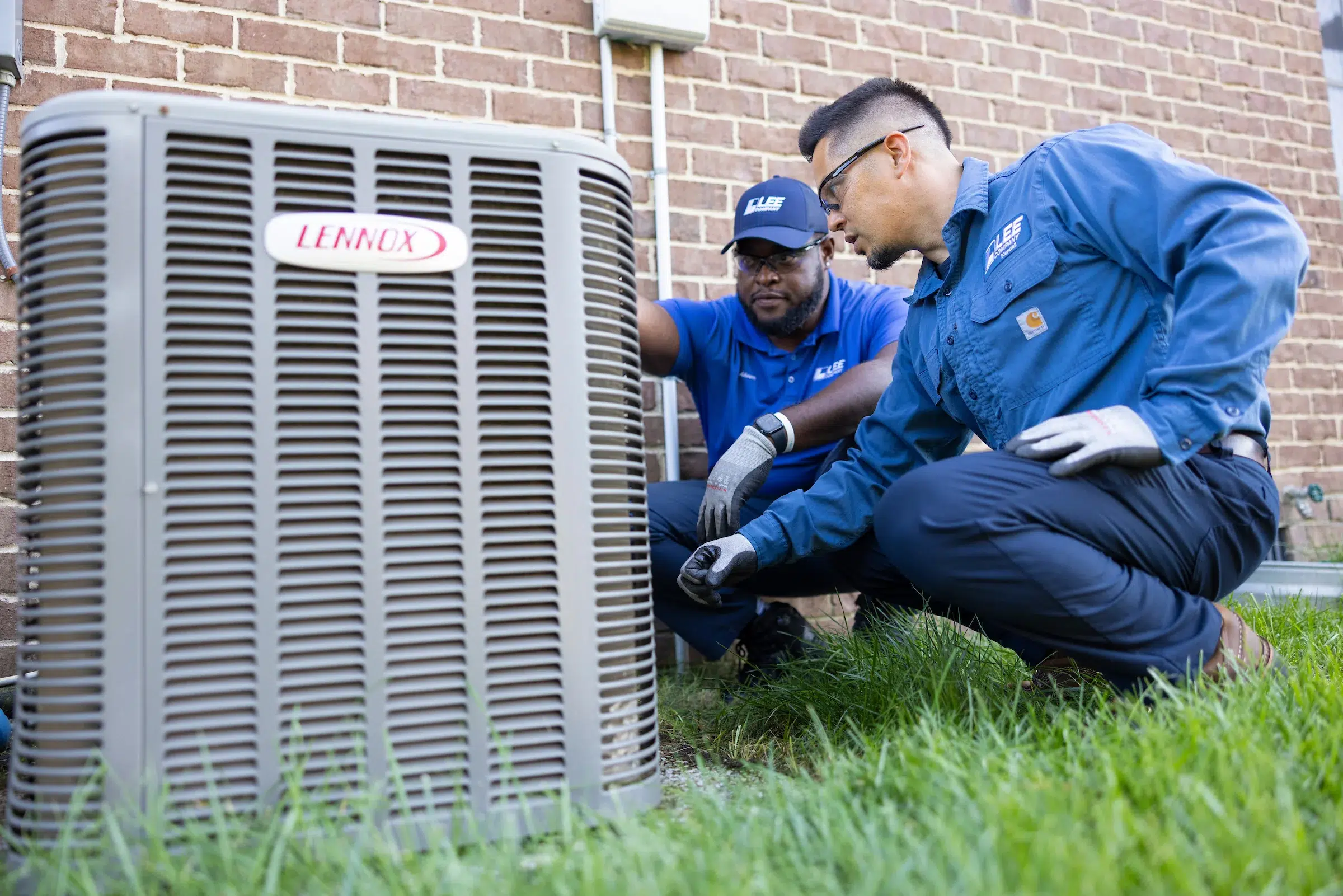 Lee Company Technicians Servicing a Residential HVAC Unit